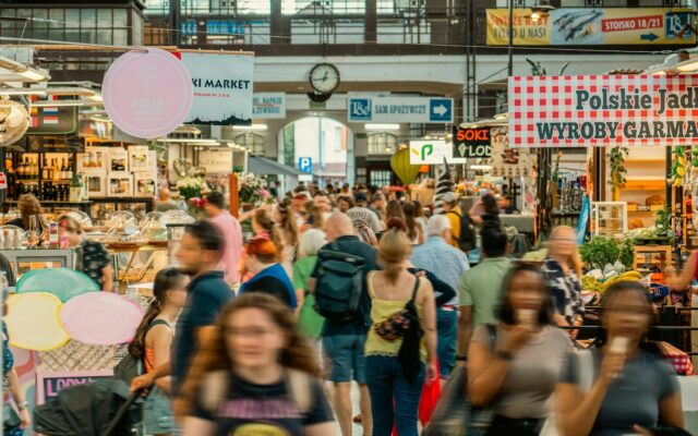 A crowd of people walking through a market