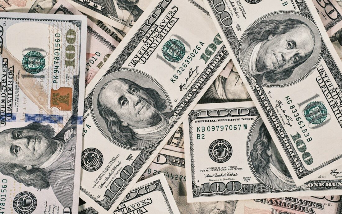 a pile of twenty dollar bills laying on top of each other