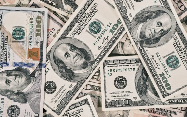 a pile of twenty dollar bills laying on top of each other